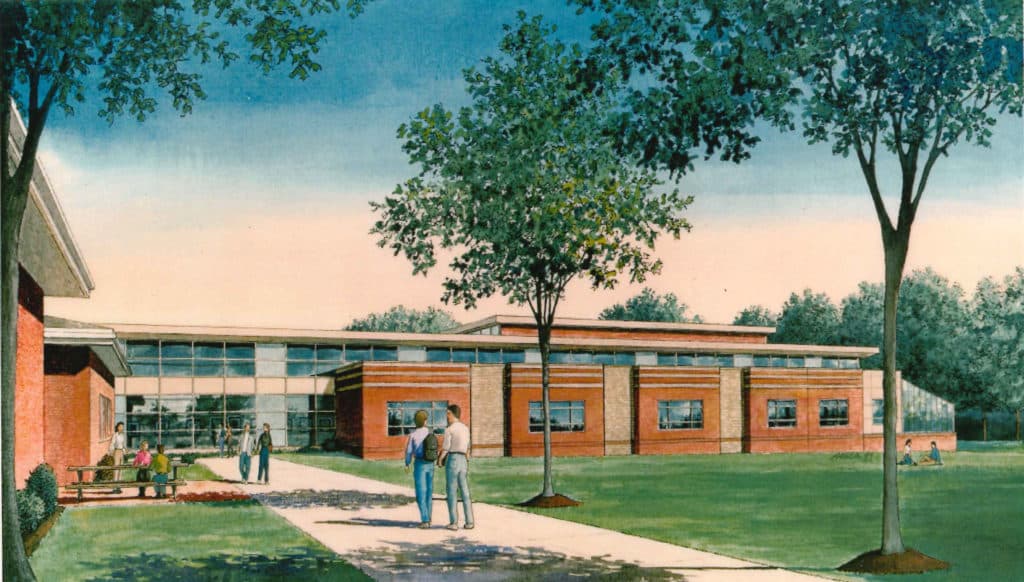 An architectural rendering of a modern school building set in a grassy area. People walk along a path leading to the entrance, with trees on both sides. The facade features large windows and a mix of brick and wood design, under a clear blue sky.